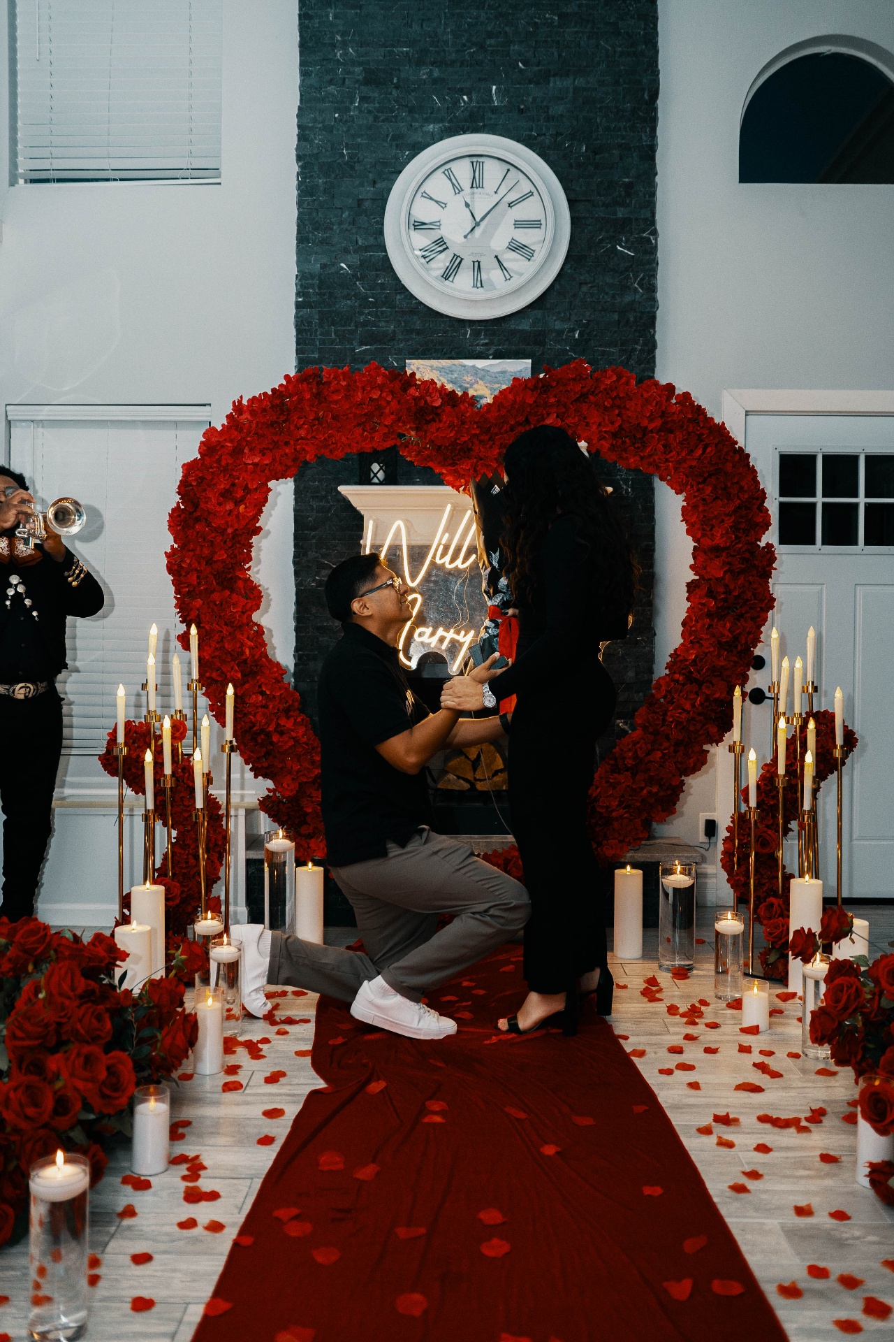 Jesus proposing to Fabiola surrounded by red roses and candles